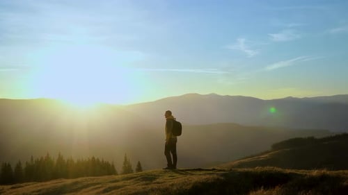 Hiker Silhouette on Mountain at Scenic Sunset