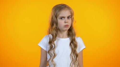 Young Girl with Blonde Hair Showing Stop Gesture