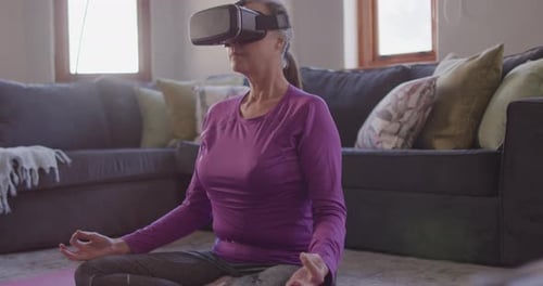 Senior Woman Meditating with Virtual Reality Headset at Home