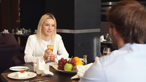 Couple Dining and Talking in Restaurant