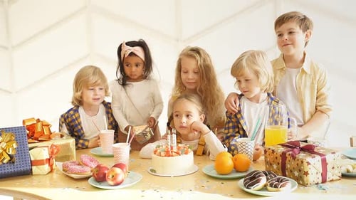Children Celebrate Birthday Around Table with Cake and Presents