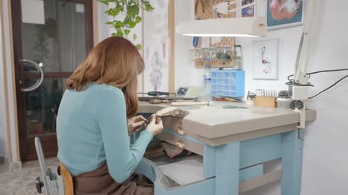 Young Freelance Jeweler Polishing In A Jewelry Workshop