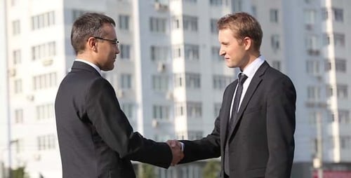 Businessmen Meeting and Shaking Hands in Urban Setting