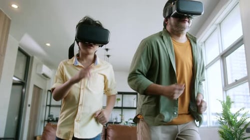 Excited Boy and Adult Explore Virtual Reality Together