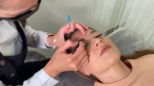 Woman Getting Eyebrow Shaping Procedure