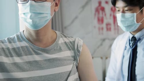 Medical Professional Giving Injection to Patient