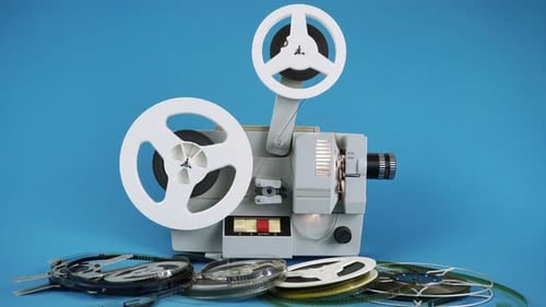 Vintage Movie Projector With Film Reels on Blue