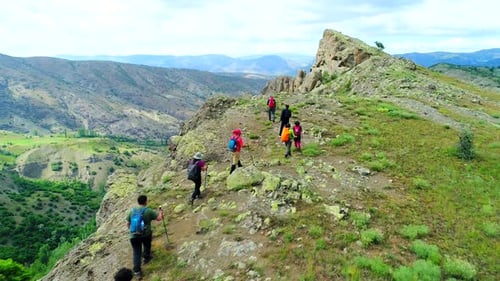 Hikers Trekking on Mountain Ridge in Daylight