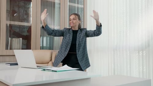 Woman Dances in Office to Celebrate Success