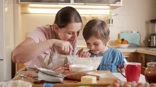 Happy Woman and Child Baking Together at Home