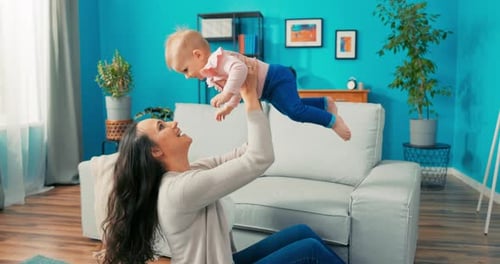 Woman Lifts Baby Up in the Air