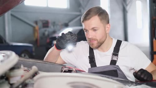 The Mechanic Inspects the Car