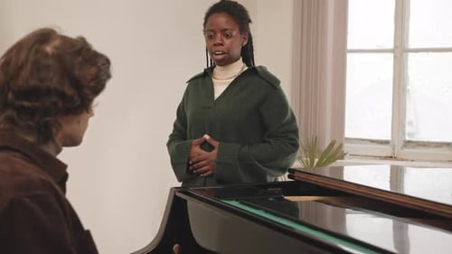 Woman Sings While Man Plays Grand Piano