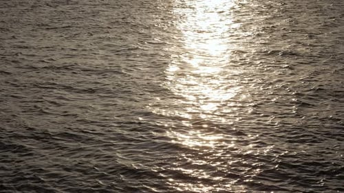 Sun Reflecting on Rippling Ocean Water at Sunset