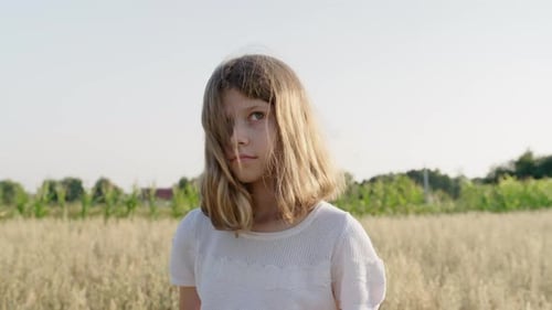 Girl Standing Calmly in a Grain Field