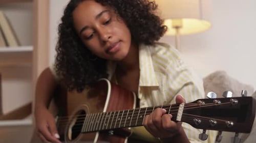 Woman Playing Acoustic Guitar Close Up Indoors