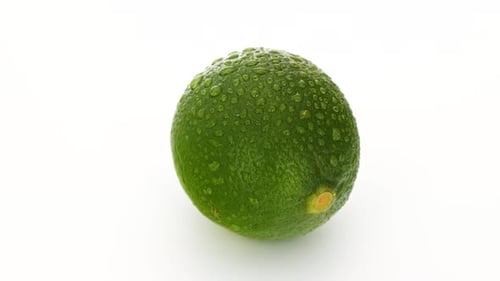 Fresh Lime Rotating Slowly on White Background