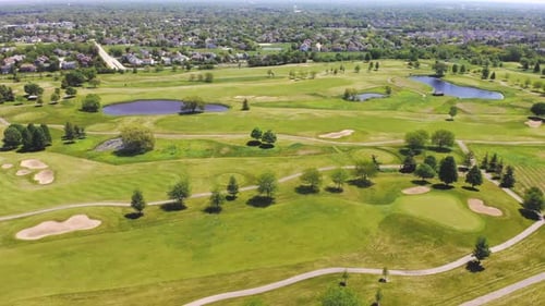 Aerial View From the Top n of the Golf Course. People and Cars on a Golf Course From a Height.