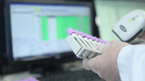 Scanning Test Tubes in Medical Laboratory Setting