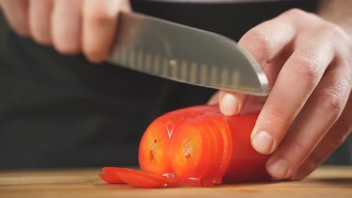 Chef Slices Red Bell Pepper with Knife