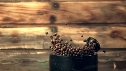 Super Slow Motion in a Mortar with Black Pepper Peas Falls Pestle