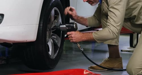 Mechanic fixing a car wheel