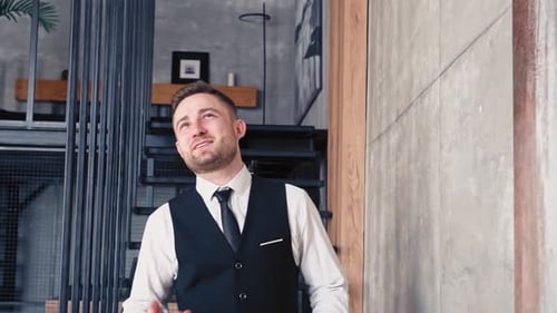 Young Man Celebrating Success Indoors