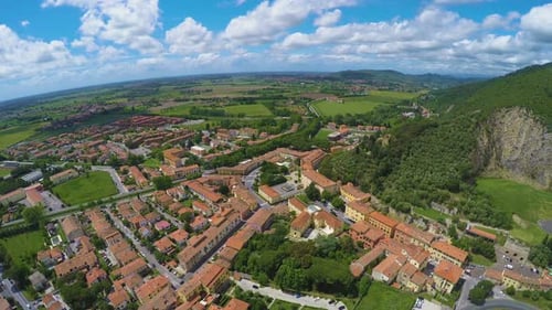 Exciting Landscape of Italian Village Lying Near Grassy Hill Under Blue Sky