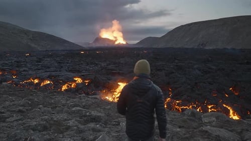 Man Walking Towards Lava Flow From Erupting Fagradalsfjall Volcano
