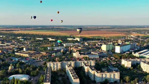 Aerial View of Cityscape with Hot Air Balloons
