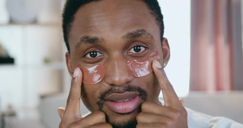 Man Using Under Eye Patches For Skin Care