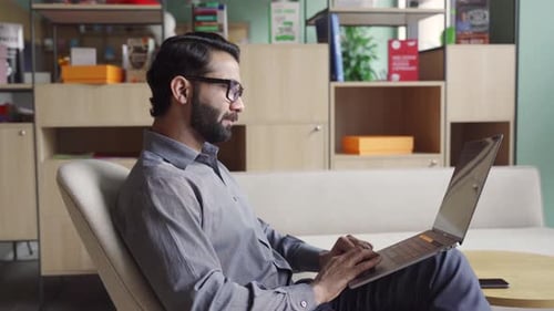 Indian Business Man Trader Investor Analyst Looking at Financial Market Charts