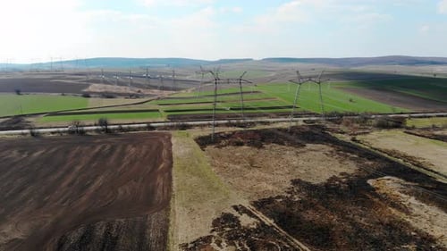 Aerial View Long Distance Transmission Lines. High-voltage Pillars That Energy Efficiently Deliver
