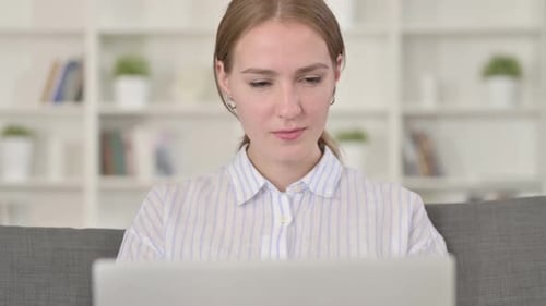 Woman Working at Home Gives Thumbs Up