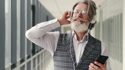 Senior Man Listening to Music with Headphones
