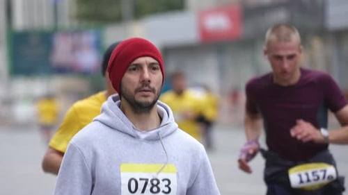 Robust Guy Runner on Sports Event Run with Crowd of Athletes on Marathon Race