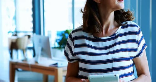 Female executive using digital tablet in office