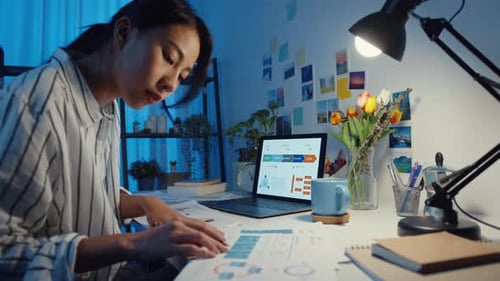 asia business lady freelance focus on laptop write worksheet finance graph account chart market plan