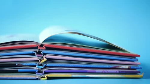 Stack of Colorful Children's Books on Blue Background