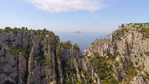 Aerial travel drone view of clear green water, cliffs of Cassis, Mediterranean Sea, Southern France.