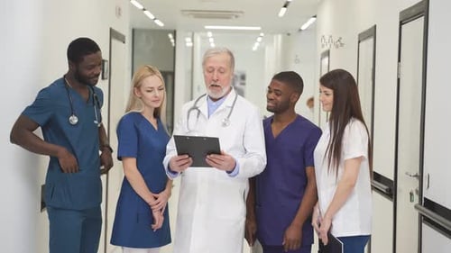 Doctor Consults with Diverse Medical Team in Hospital