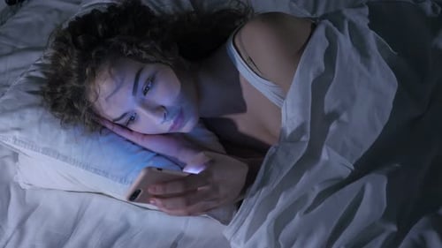 Female Using Smartphone at Night, Scrolling