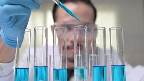 Scientist Working with Test Tubes in Laboratory
