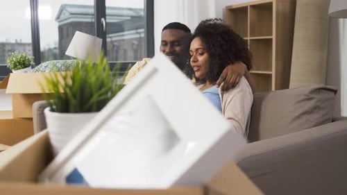 Young Couple Relaxing with Tablet in New Home