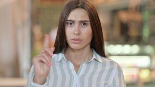 Young Latin Woman Saying No By Finger