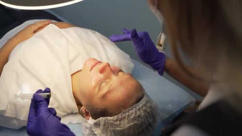 Woman Receiving Cosmetic Procedure in Clinic