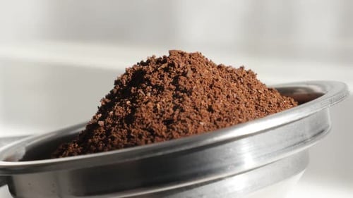 Coffee Grounds Filling Metal Portafilter Close Up