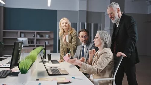 Team Discussing Ideas at Workplace in Office