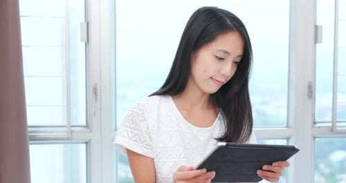 Woman use of tablet computer at home