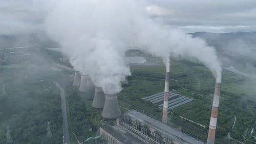 Aerial Drone View of Smoking Pipes and Cooling Towers of Coal Thermal Power Plant